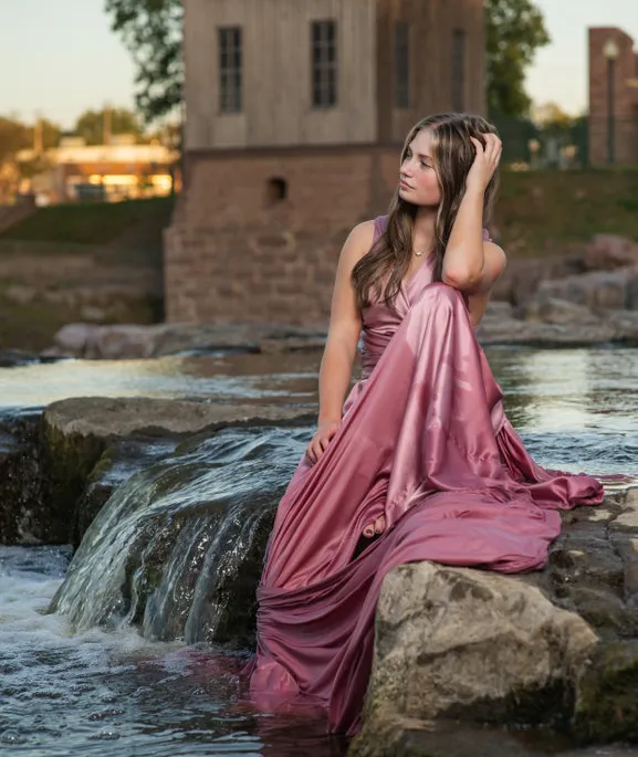 Senior photo near a stream of water